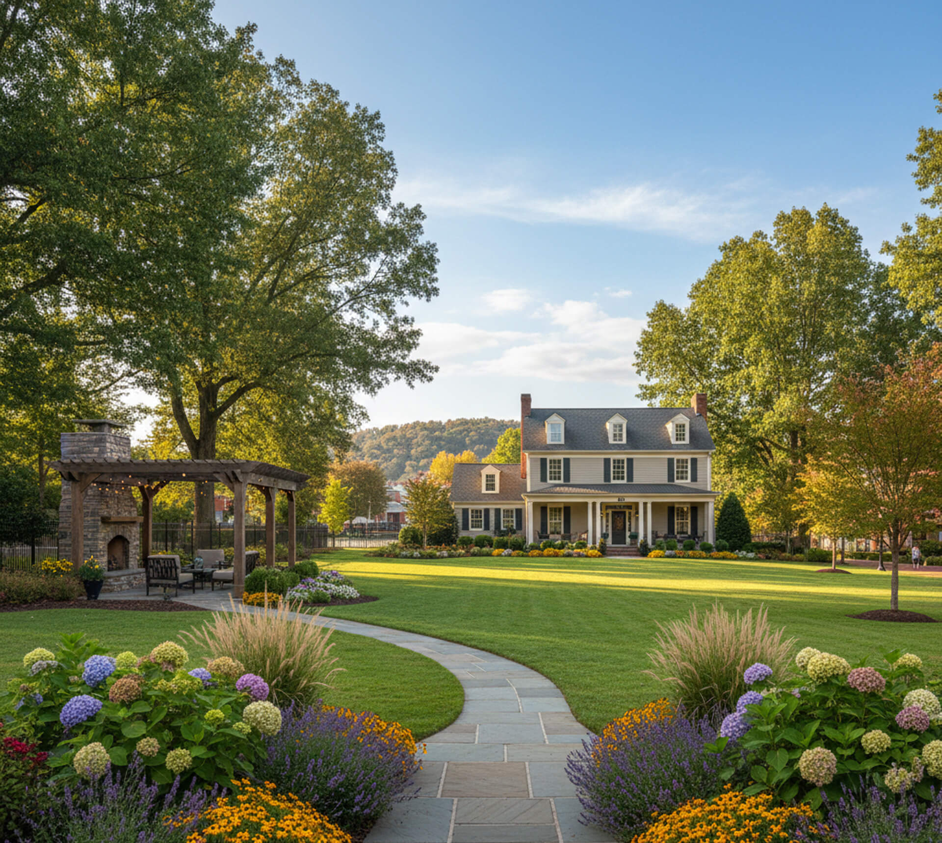 Elegant home with manicured lawn, colorful flower beds, and a charming gazebo in Ashland, VA, showcasing professional landscaping services.