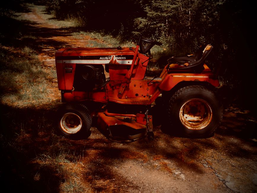 Vintage tractor in Richmond VA preparing lawn for spring growth.